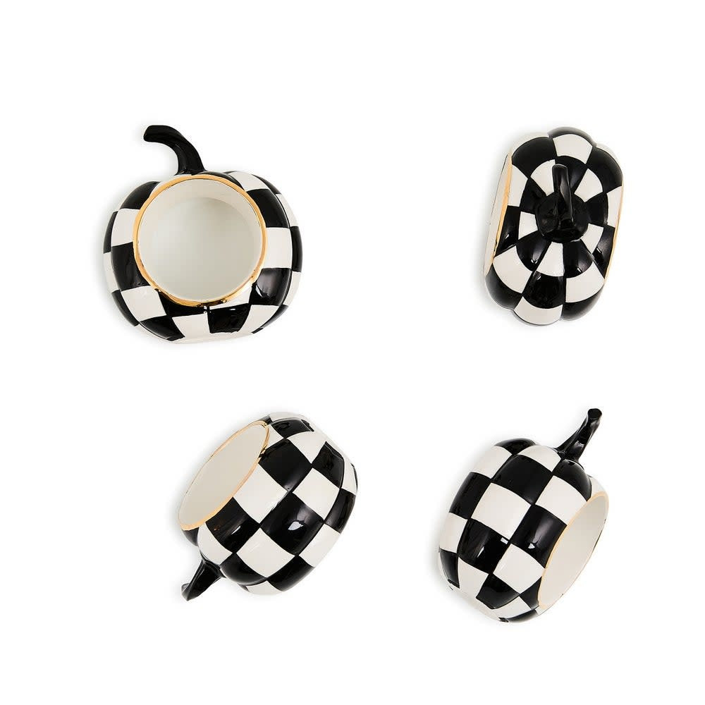 Set of four black and white ceramic napkin rings with a courtly check pattern.