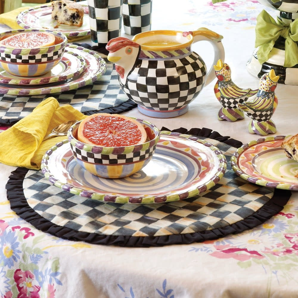 Round Courtly Check placemat with black ruffled edge trim on cotton fabric.