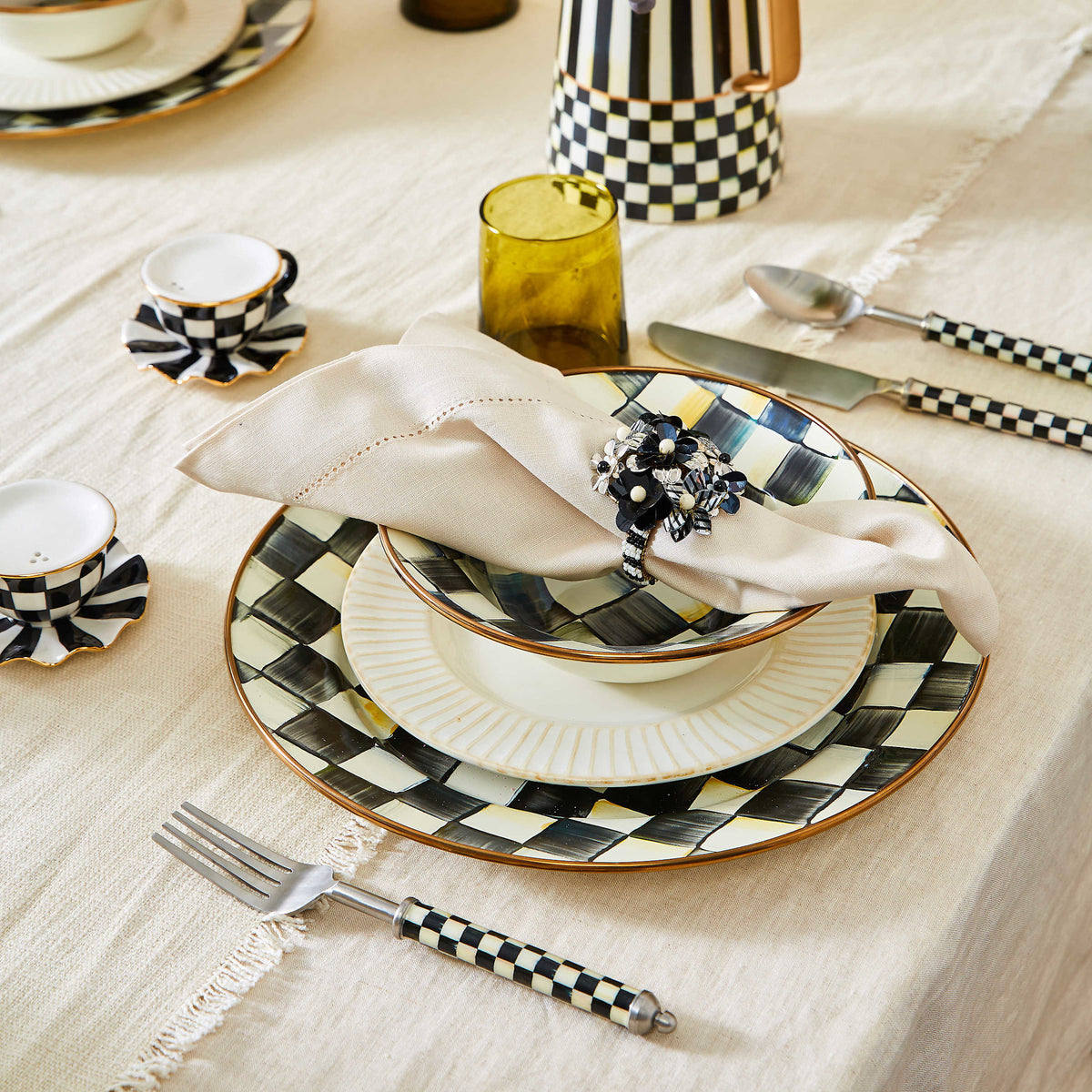 Three-piece stainless steel place setting with clear enamel checkered handles