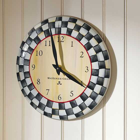 Round wall clock with Courtly Check enamel face, bronzed stainless steel rim, and heavy-gauge hand-glazed steel body.