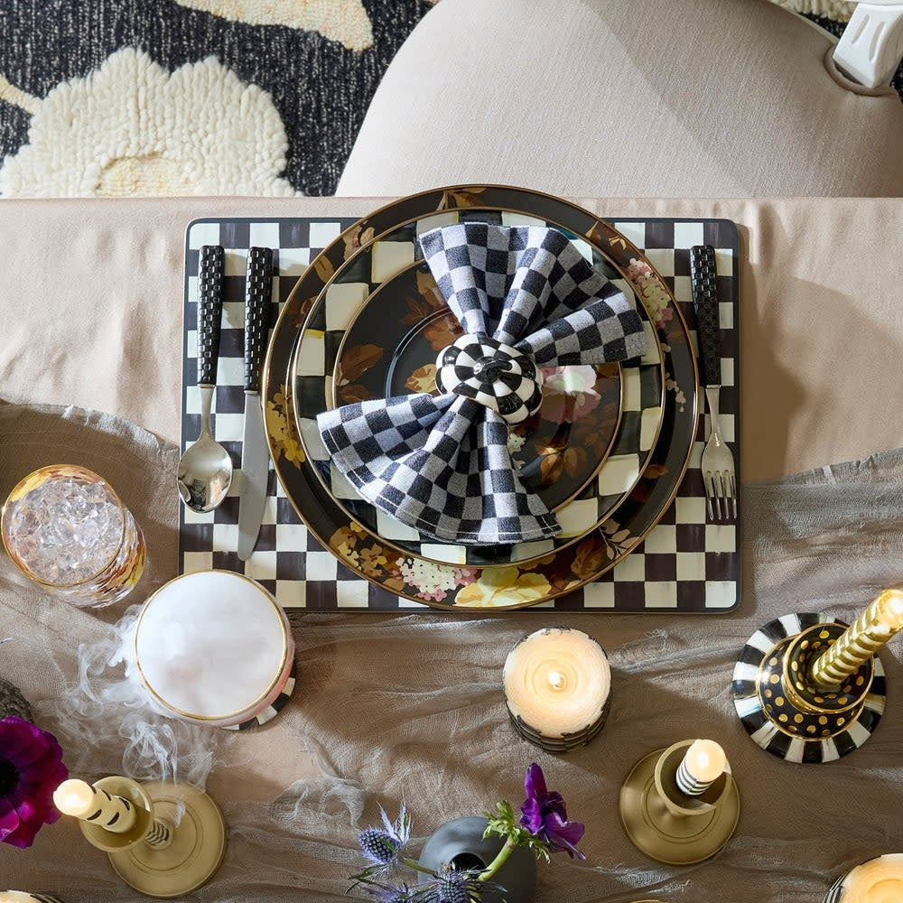 Set of four black and white courtly checked MDF placemats with cork backing.