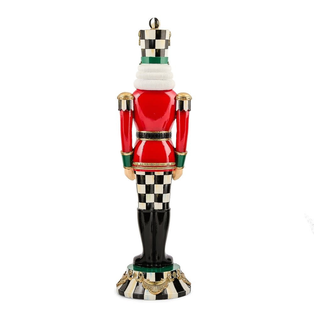 Tall red resin nutcracker with Courtly Check accents standing upright.
