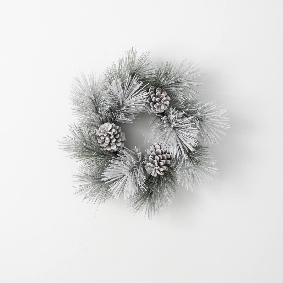 Green flocked pine ring wreath with faux snow-dusted cones
