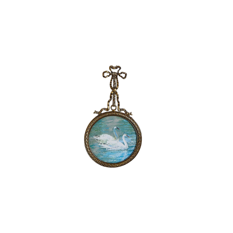 Round antique pewter hanging frame with bow detail, featuring a painting of two swans on water.