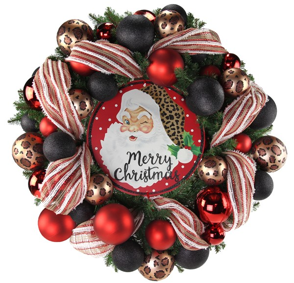 Christmas wreath with animal print, red, and black ornaments, striped ribbon, and a Santa sign.