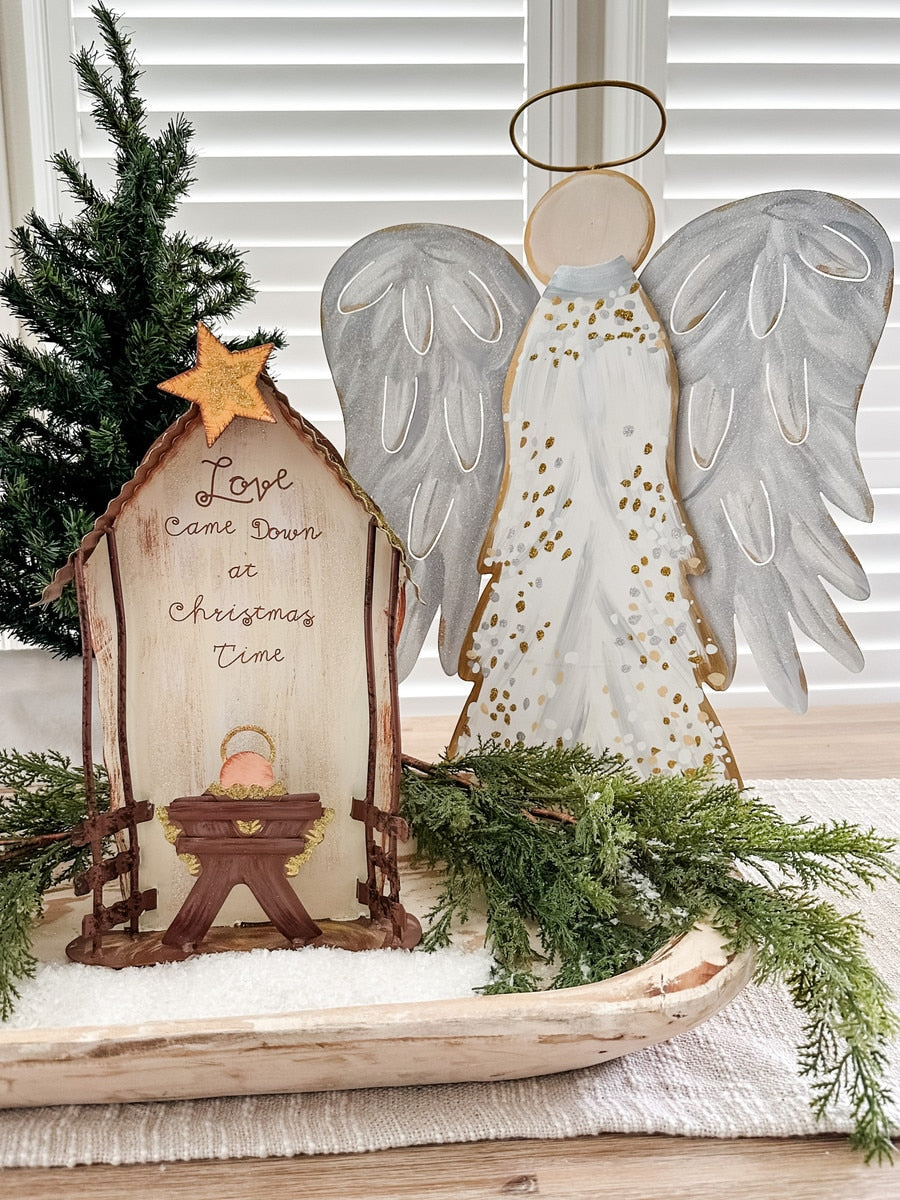 Love Came Down Nativity stake featuring a brown wooden figure with gold accents depicting the birth scene.