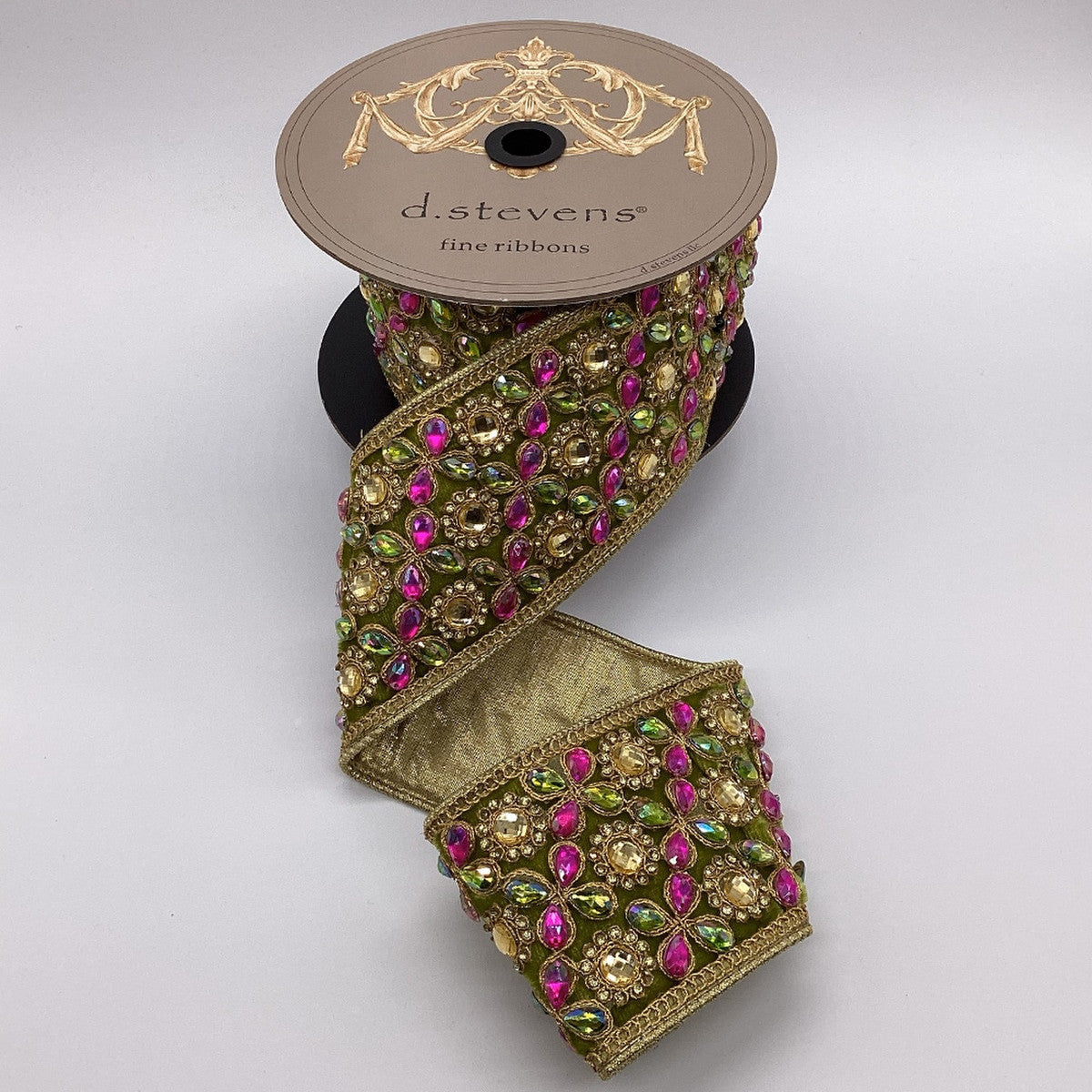 3-inch gold velvet ribbon with hot pink and lime green marquess jewel trim on a spool.