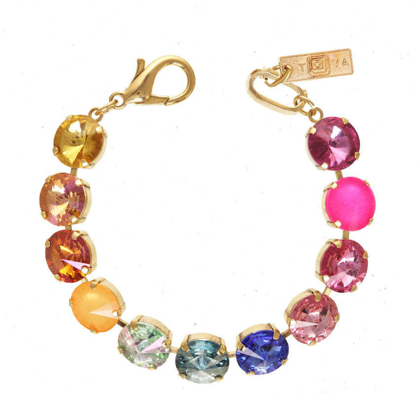 Antique gold plated brass Croatia bracelet with high-quality crystals on a watermelon mix background.