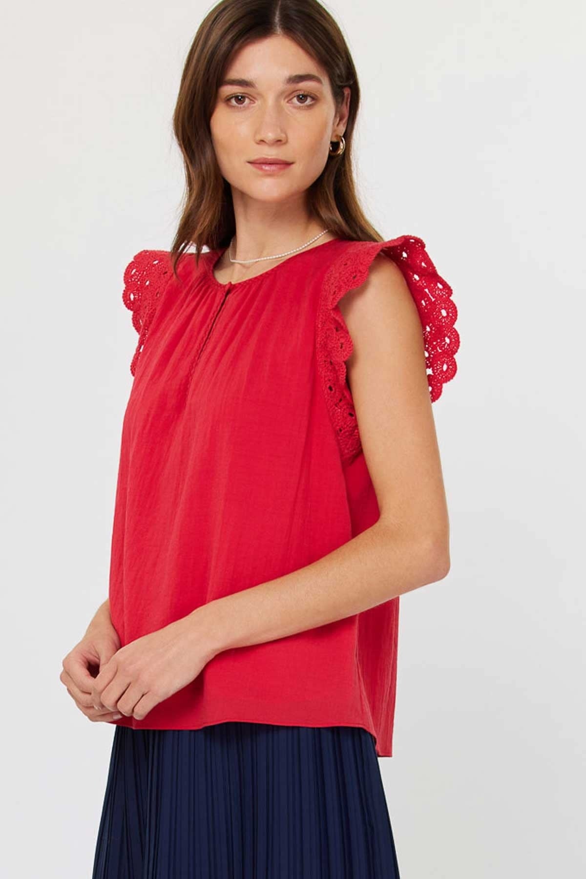 Red crochet blouse with short sleeves, round neck, front buttons, and side keyhole detail.