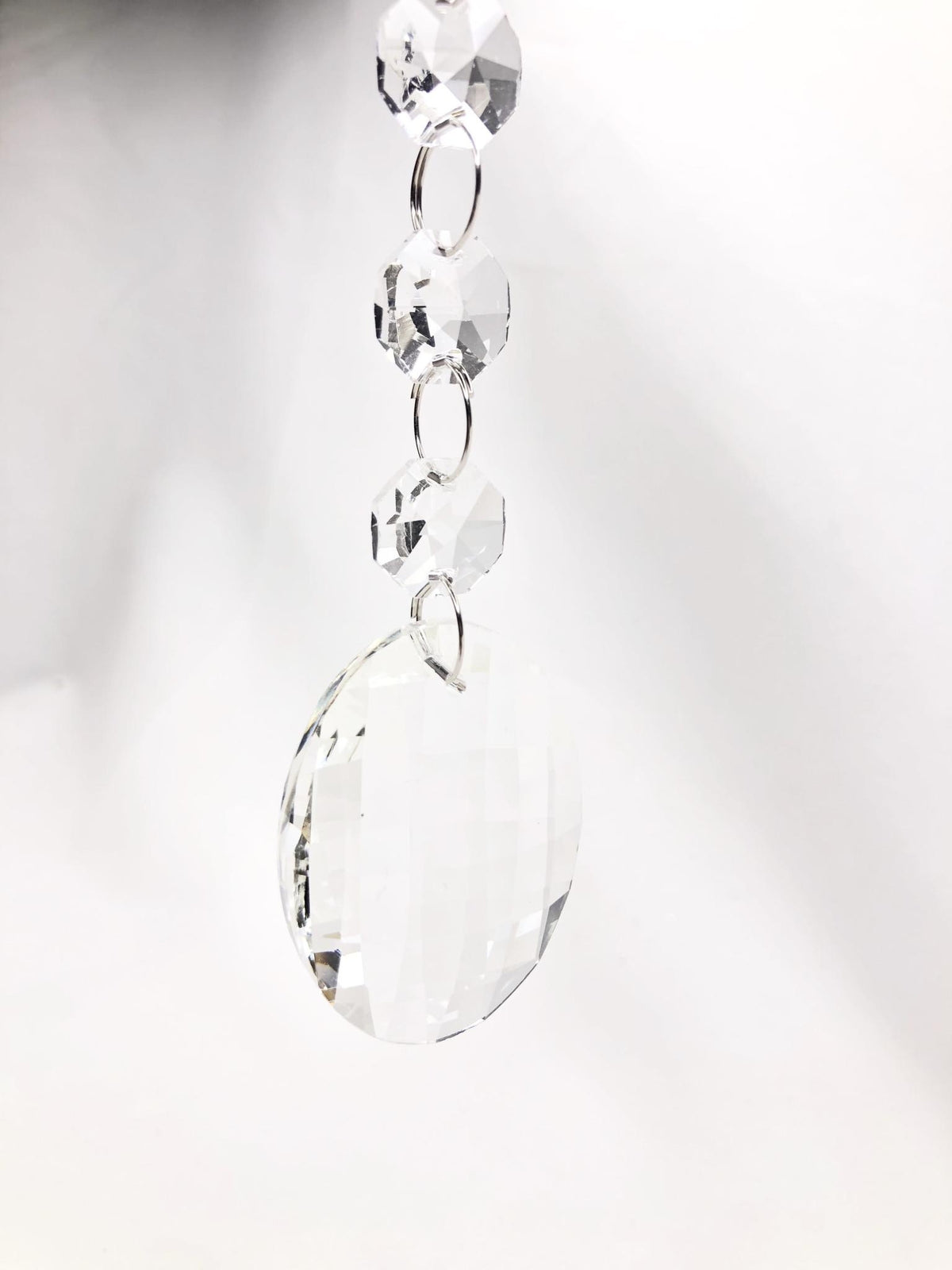 Glass crystal drop ornament with faceted jewels in clear color.