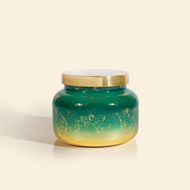Crystal Pine Glimmer jar candle with emerald green wax, metallic foil accents, and frosted fir scent.