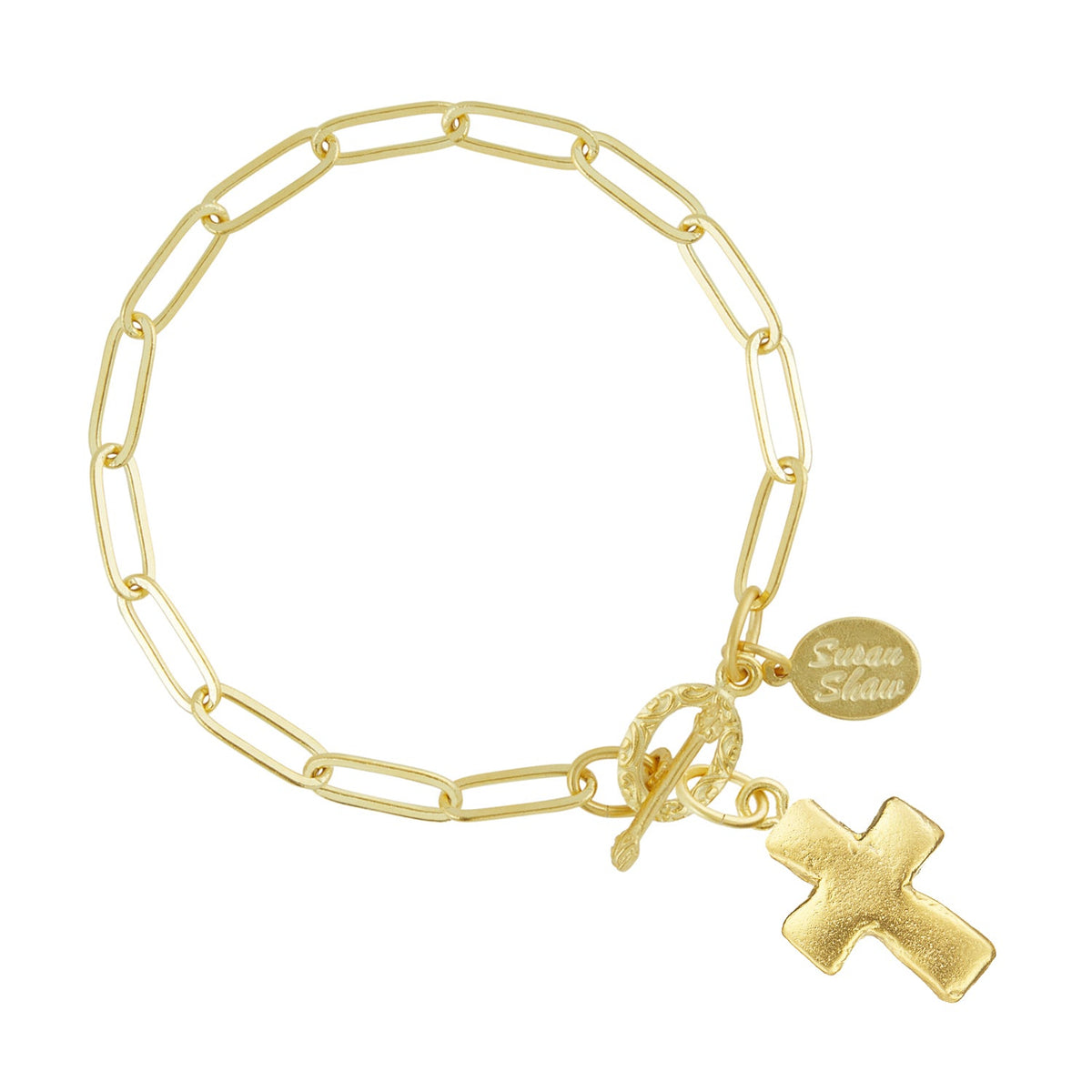 Gold paperclip chain bracelet with a small cross pendant, toggle clasp, and Susan Shaw logo tag.