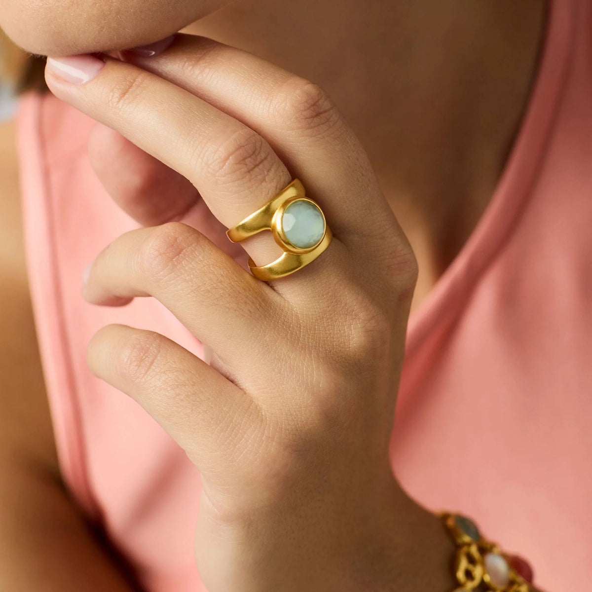 Adjustable Laguna Stone ring with imported glass stone set in a polished gold-plated band.