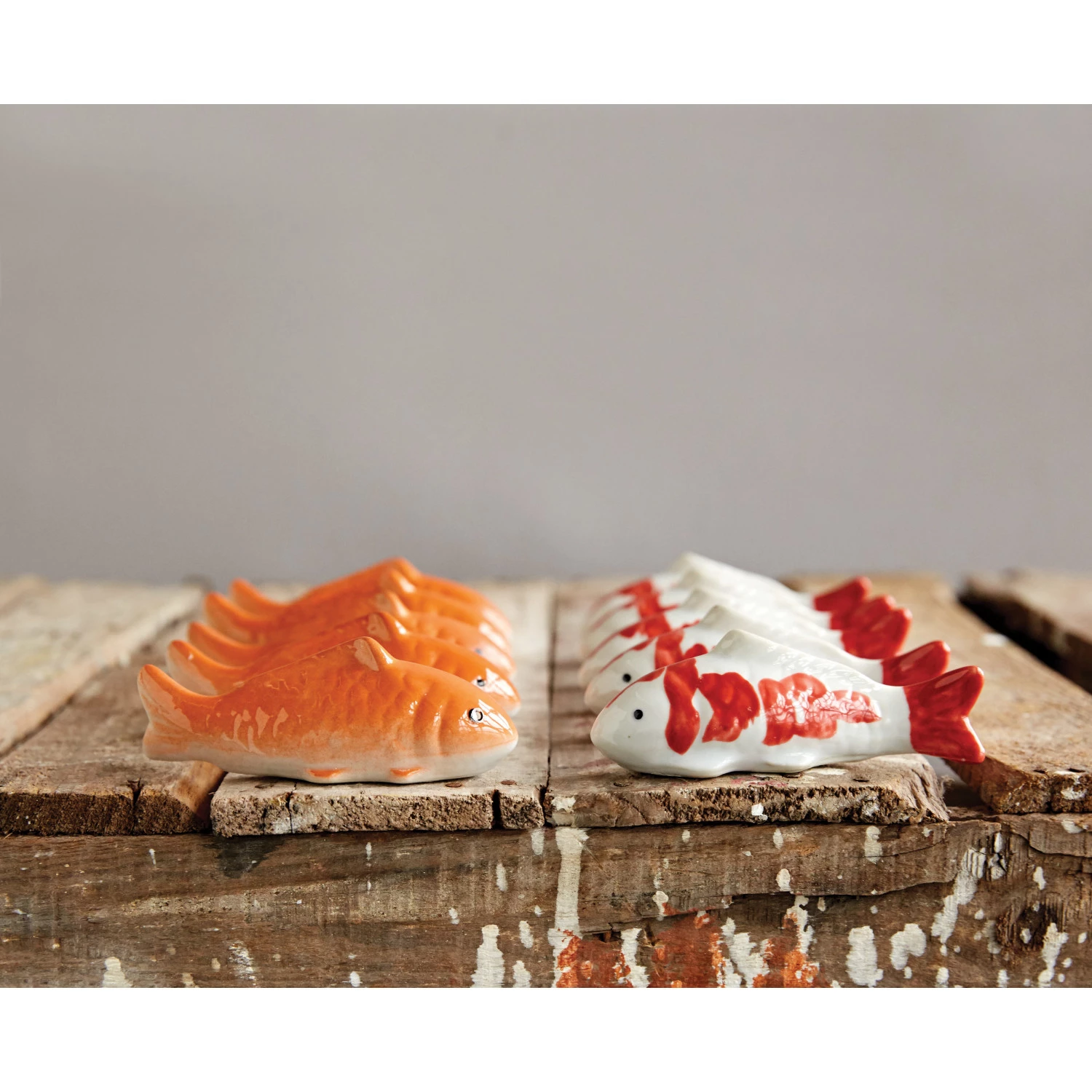 4-inch stoneware floating fish figurine in natural color with smooth silhouette.