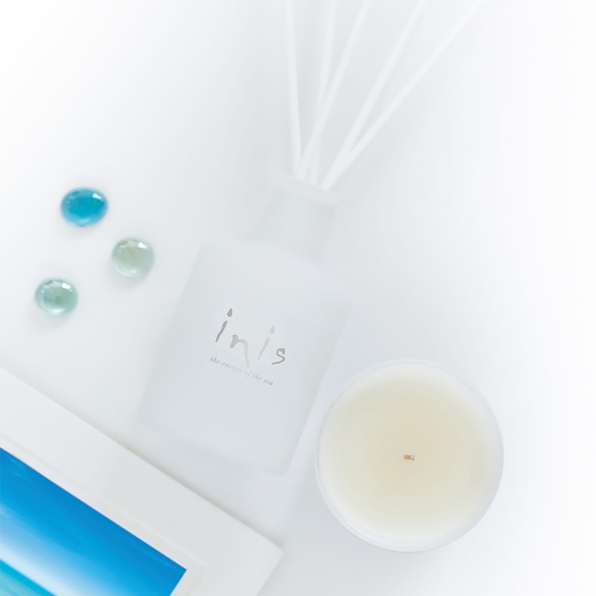 Frosted glass Inis fragrance diffuser with fibre wick reeds holding sparkling scent oil.