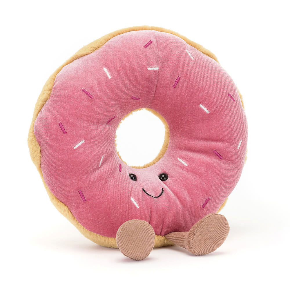 Sitting Jellycat Amuseable Doughnut with golden polyester dough, berry-pink icing, rainbow sprinkles, and cordy fudge boots.