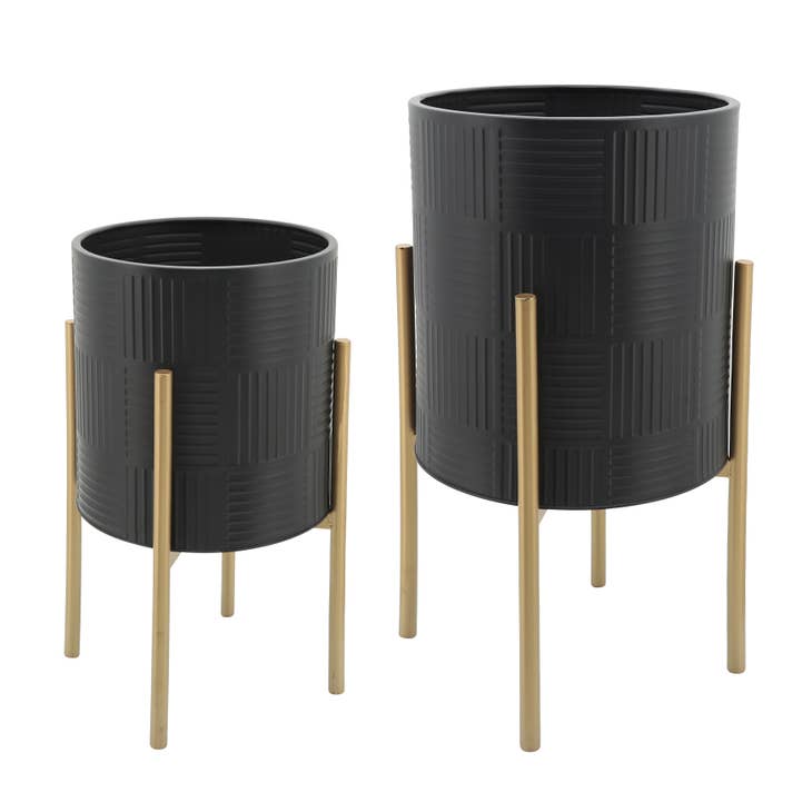 Black metal planter with gold lines on a stand