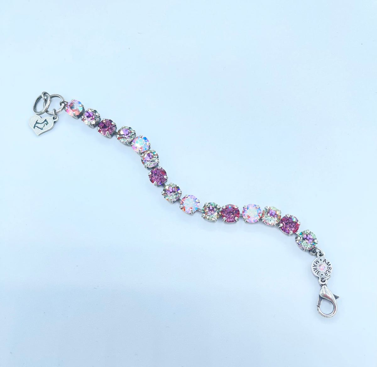 Classic Paris bracelet featuring lavender, lilac, white, and light green stones with an amber tag heart charm.