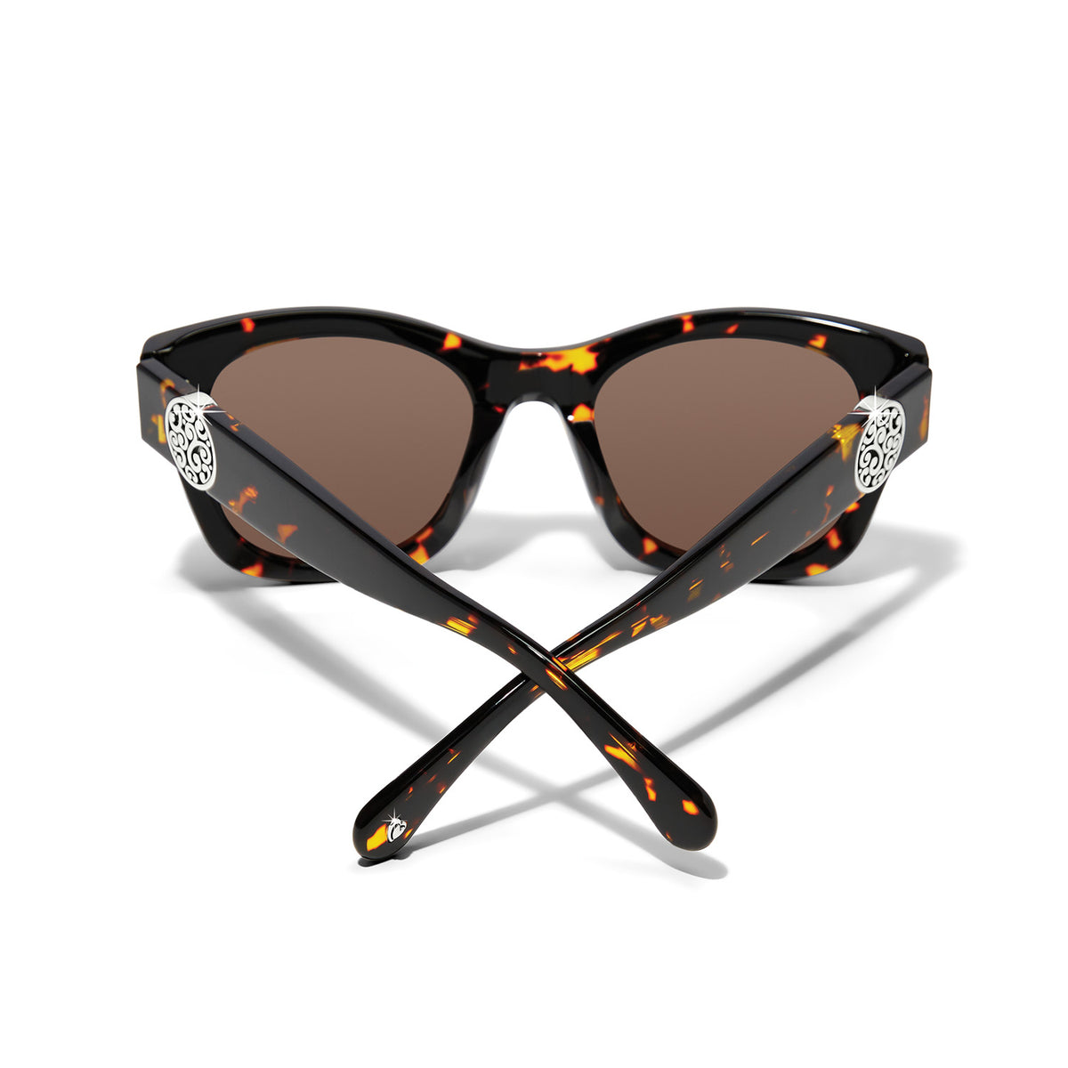 Tortoise shell cat eye sunglasses with silver plated medallion accents and brown lenses.