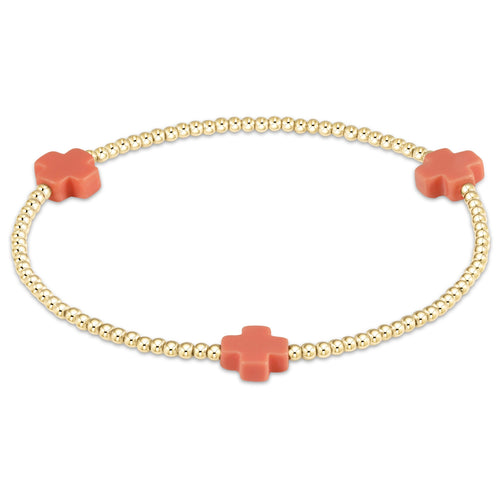 Gold-filled Signature Cross bracelet with a cross bead pattern on elastic cord