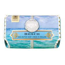 Large rectangular shea butter soap bar with a beach ocean scene and a decorative wax seal emblem.