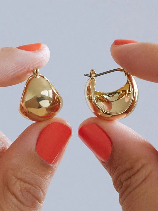 Abby gold hoop earrings featuring a polished circular silhouette with a titanium post clasp.