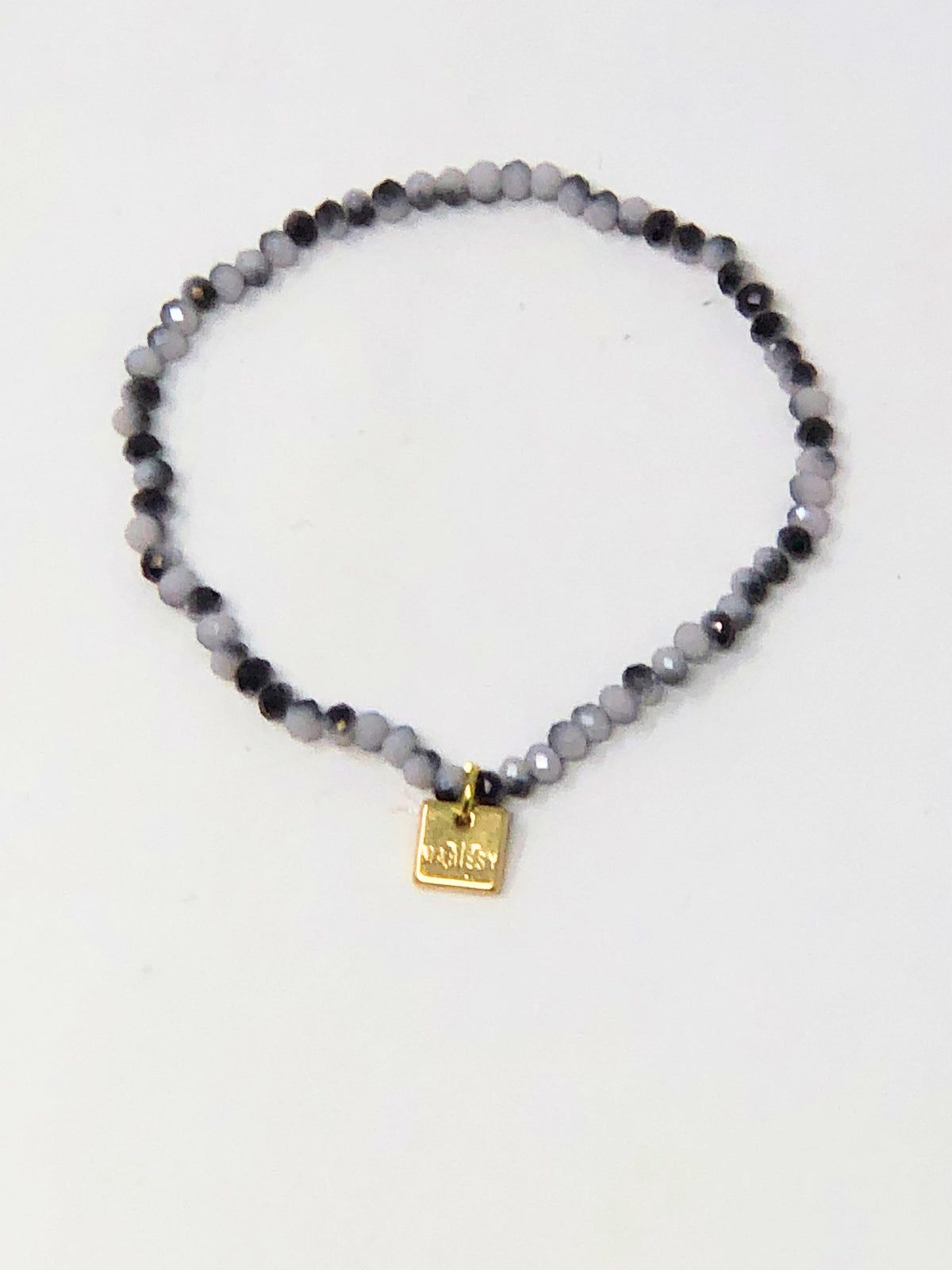 Stretchy bracelet with faceted glass beads in a colorful beaded pattern.