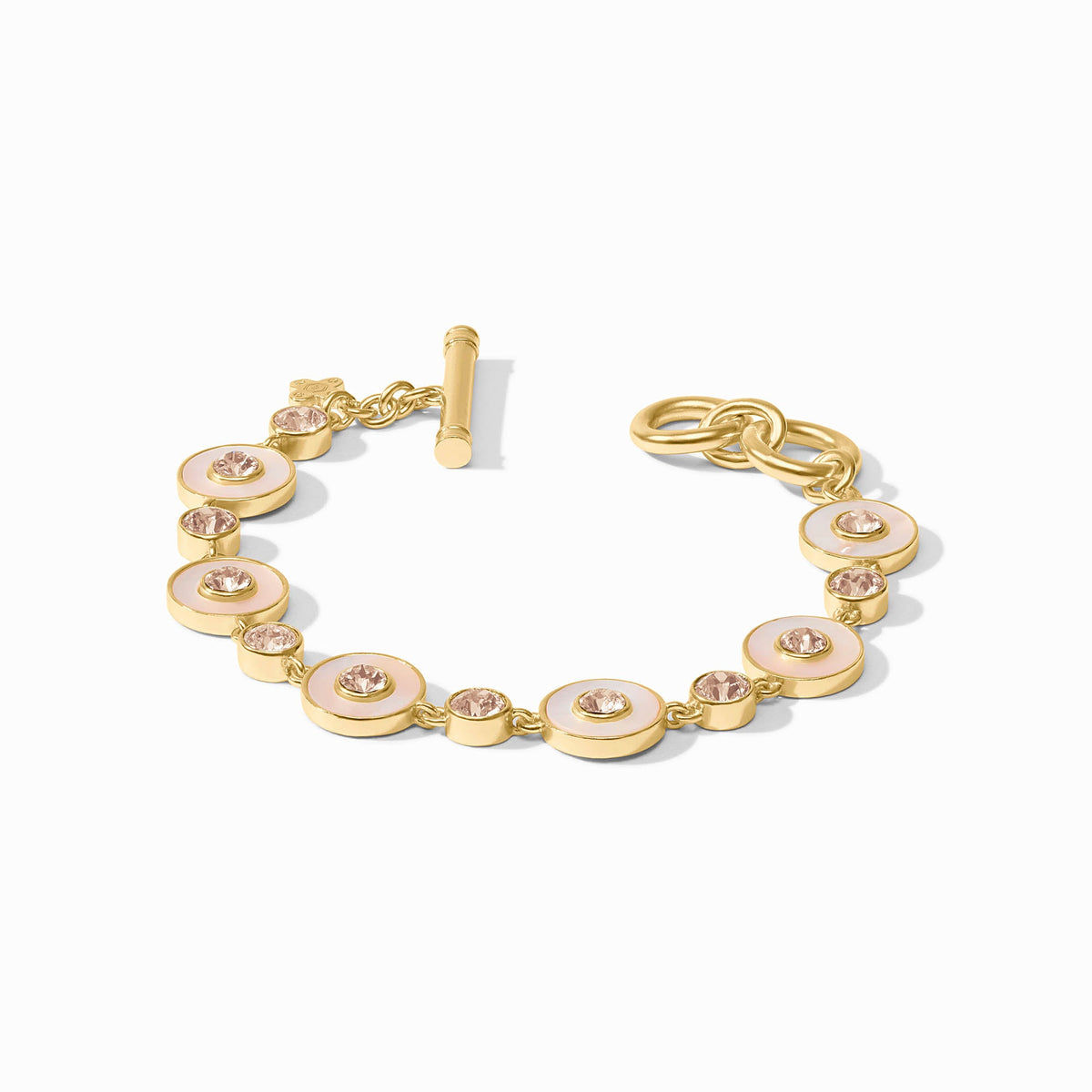 Adjustable Colette tennis bracelet featuring gold plating, cubic zirconia stones, and a mother-of-pearl center with a toggle clasp.