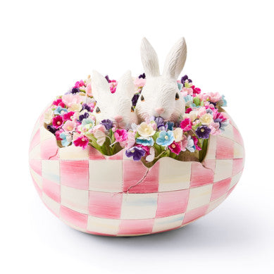 Resin peekaboo egg toy in bubblegum pink with a check pattern and hidden face silhouette.