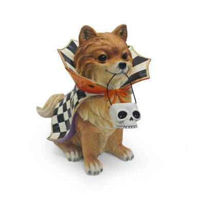 Trick or Treat Pomeranian Dog Figurine wearing a checkered cape and holding a skull bucket.