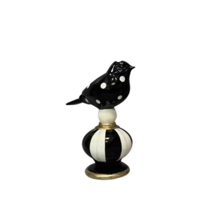Black and white polka dot bird figurine perched on a striped Courtly Check base with gold accents.