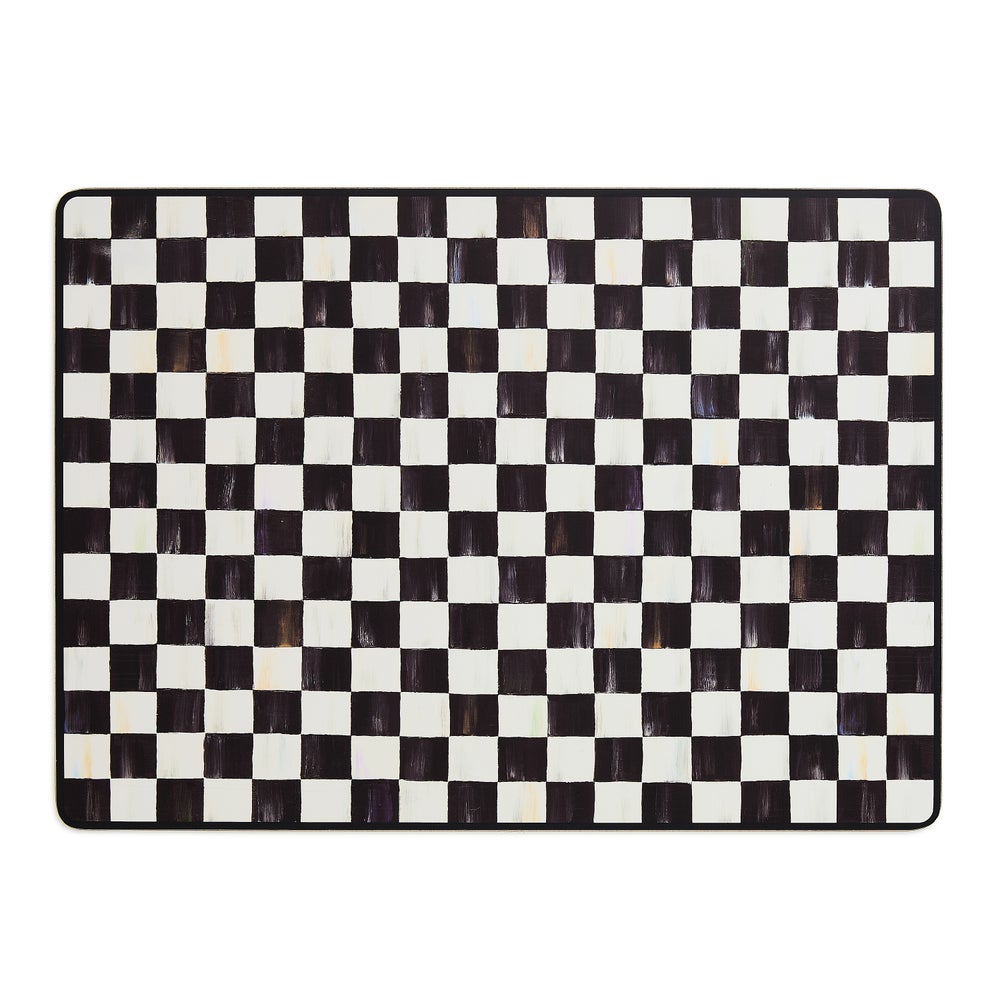 Rectangular cork-backed placemat with a hand-painted black and white checkered pattern.