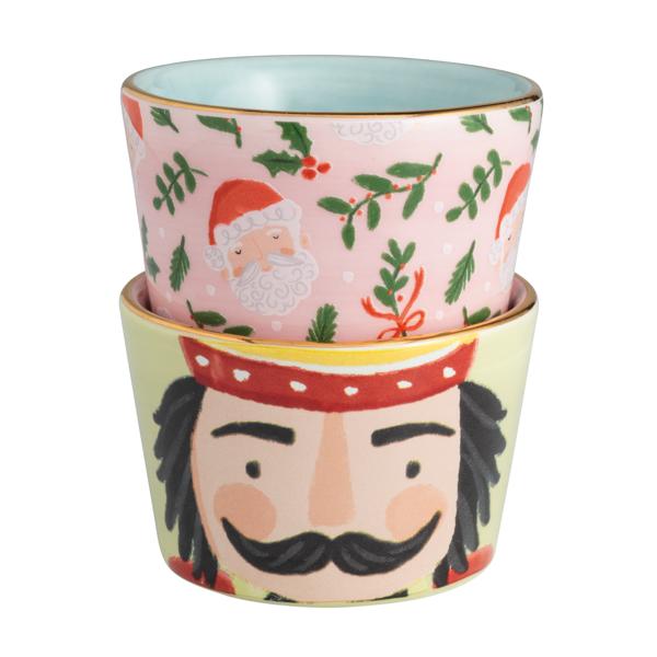 Set of two stacked ceramic tidbit dishes featuring a pink Santa pattern and a nutcracker face.