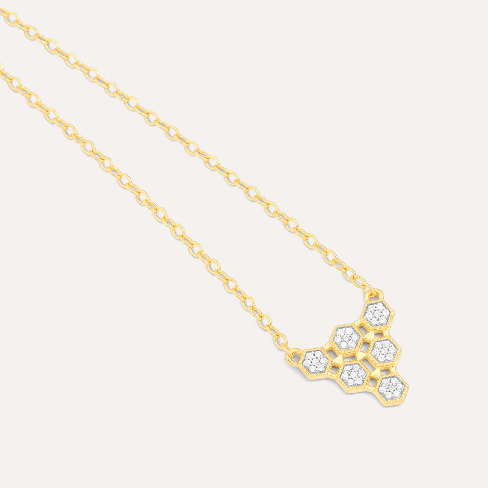 Gold honeycomb pendant necklace featuring six diamond-studded hexagonal shapes on a link chain.