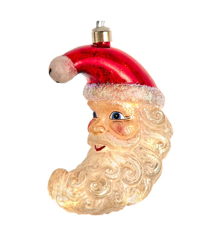 Glass Santa moon ornament with a red glittered hat and warm white LED lights inside.