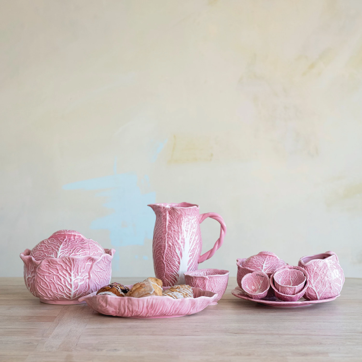 Pink stoneware cabbage-shaped baker with a round base.