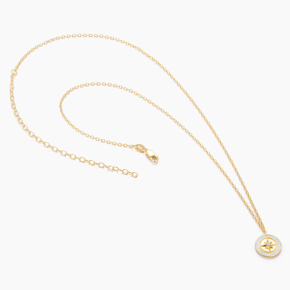Sterling silver compass pendant necklace with gold-plated finish on a chain