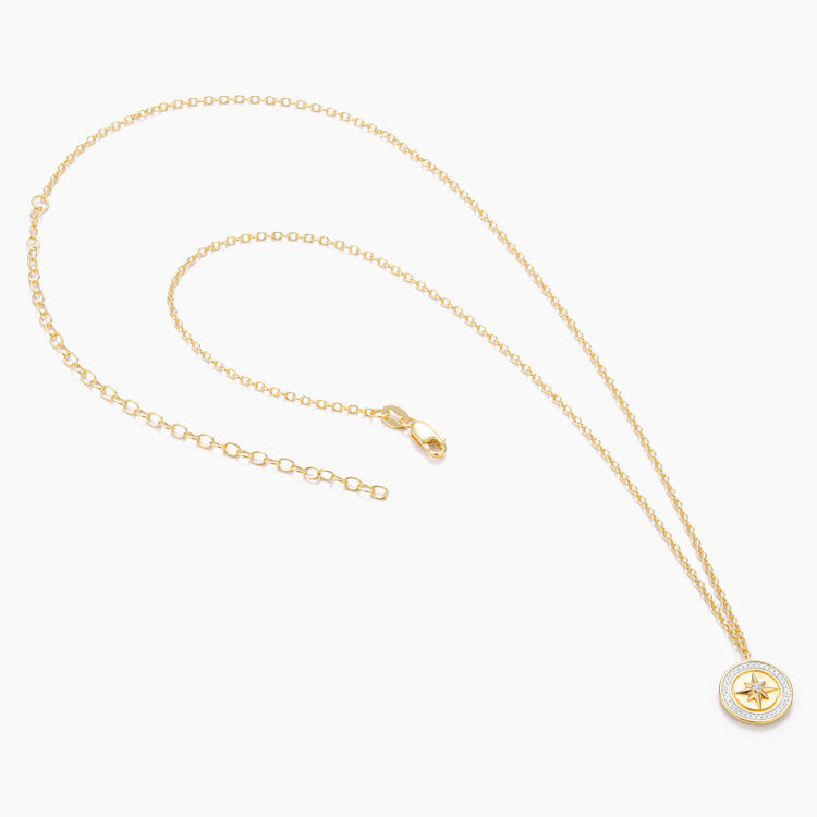 Sterling silver compass pendant necklace with gold-plated finish on a chain