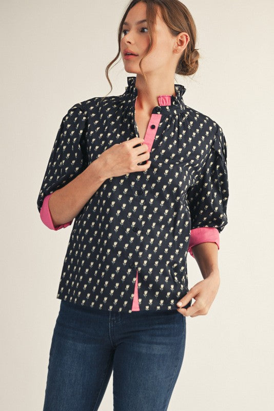 Women's floral button-down top with ruffled neckline, solid contrast trim, three-quarter sleeves in cotton.