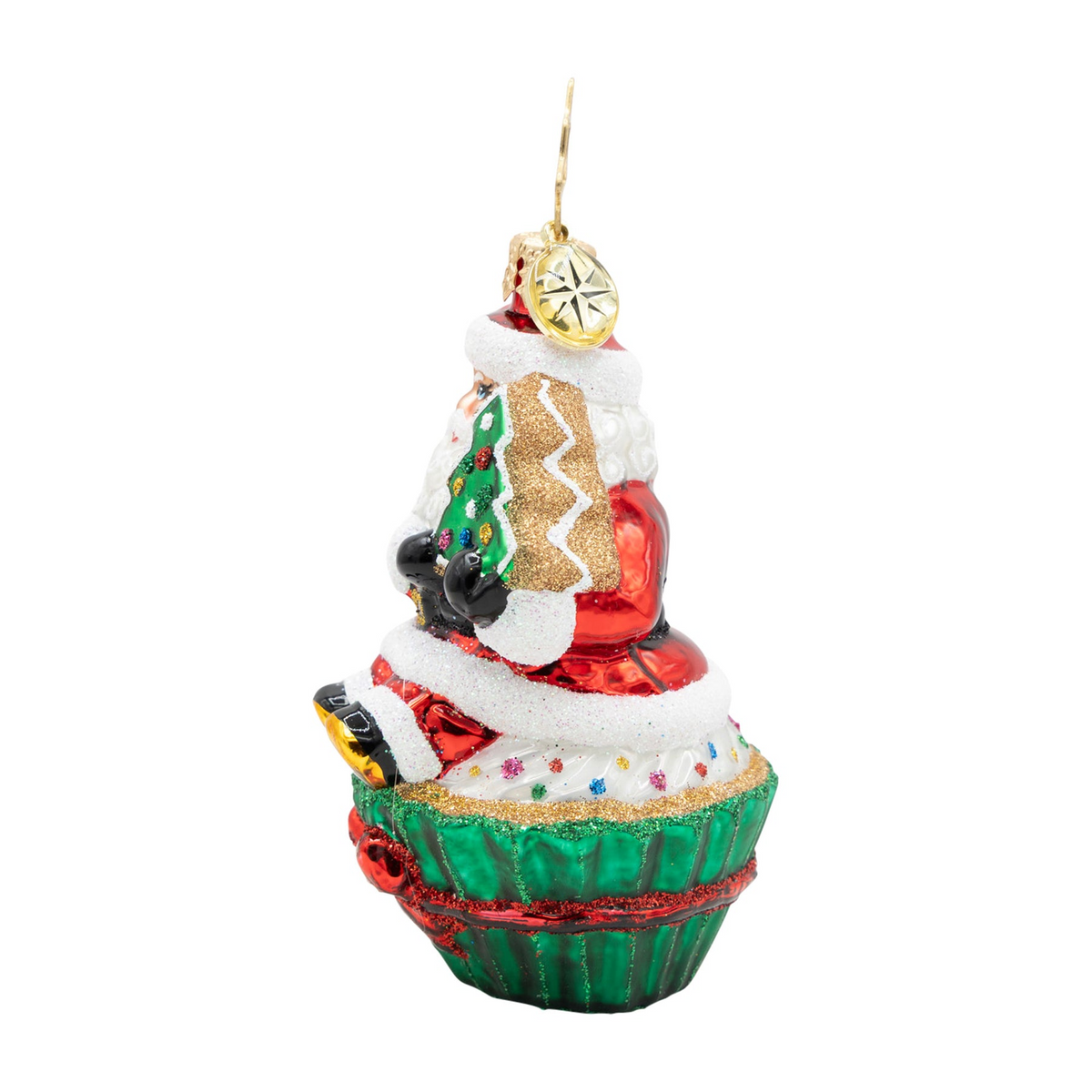 Glass Santa Claus ornament sitting on a green cupcake with white frosting and colorful sprinkles.