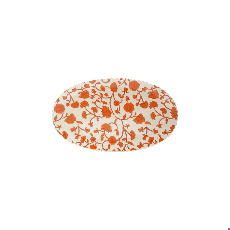 Oval stoneware scalloped tray with an orange floral vine pattern on a cream background.