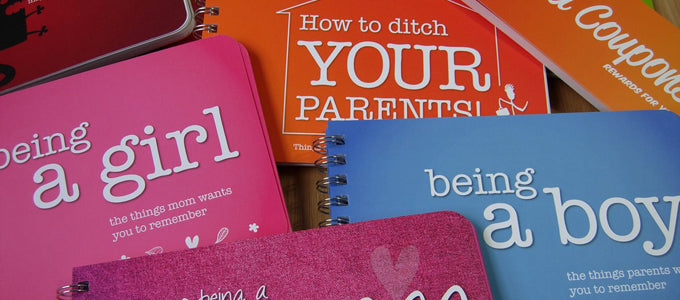 Collection of spiral-bound handbooks: "being a girl", "being a boy", "How to ditch YOUR PARENTS!", and "Coupons".