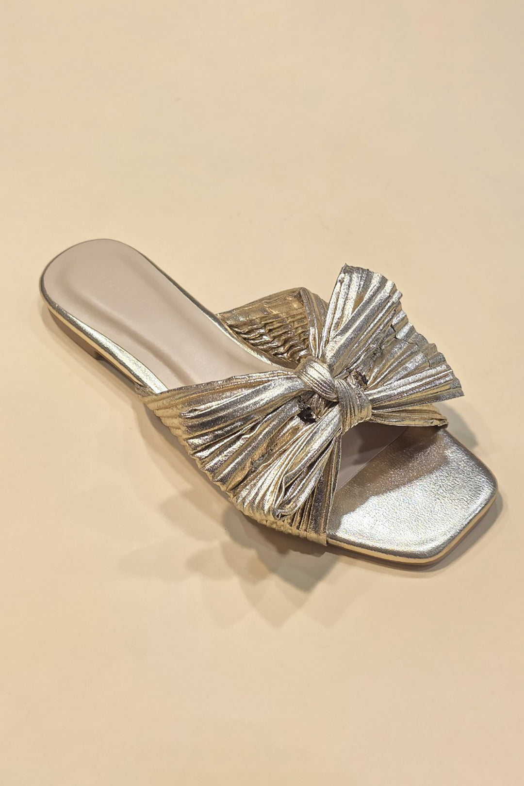 Metallic fabric ribbon slide flat sandals with a sleek strap across the toes.