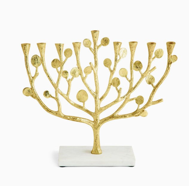 Antique goldtone marble menorah with botanical leaf detailing holding a candle