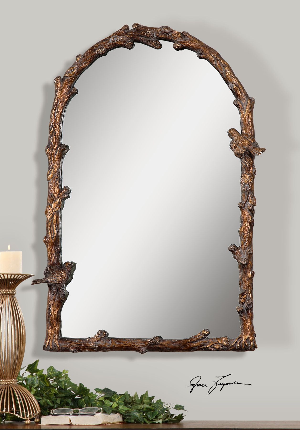 Antique gold arch mirror with a decorative frame