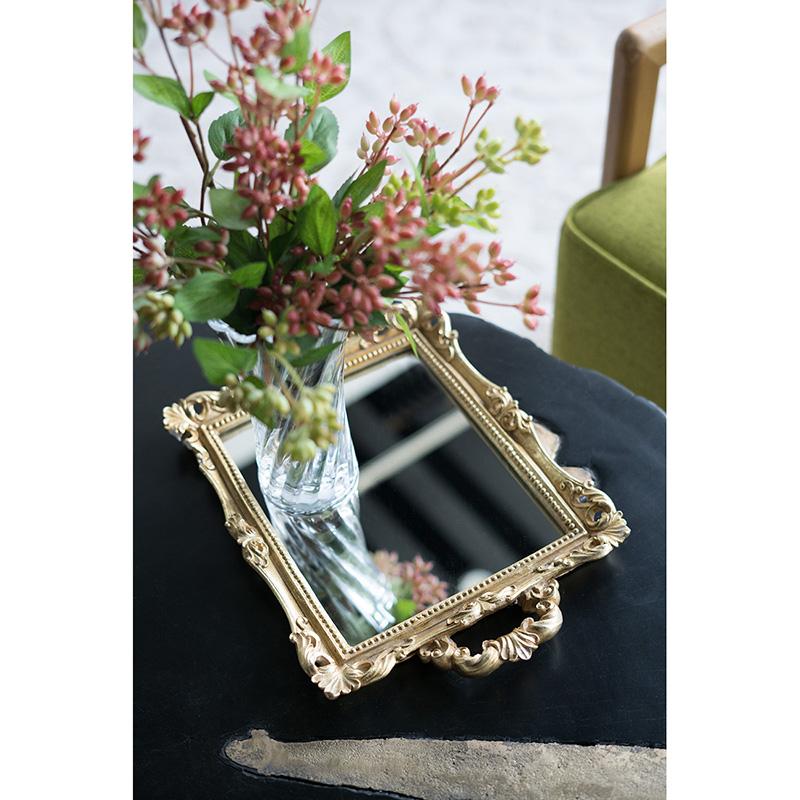 Small rectangular mirror tray with two handles in a neutral finish.