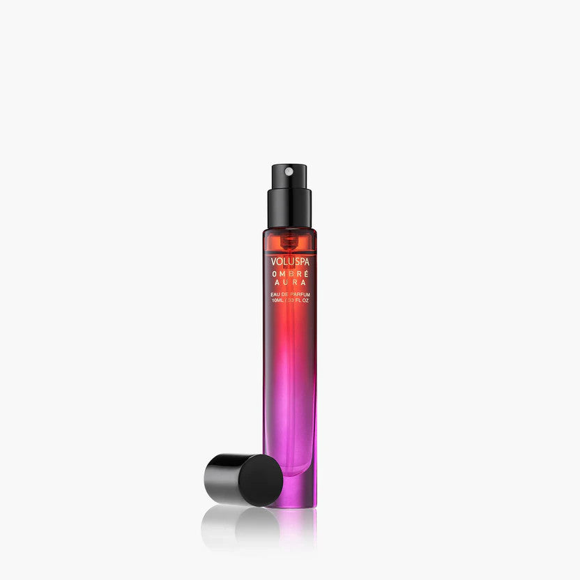 Bottle of Ombre Aura Eau De Parfum with warm amber liquid inside a clear glass container.