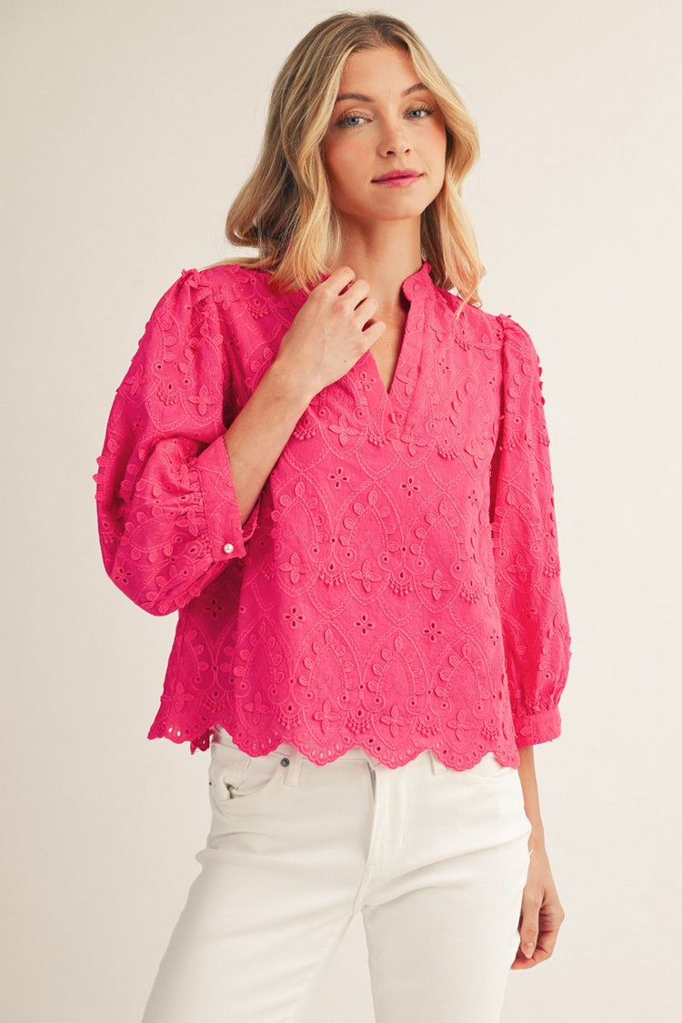 Woman wearing a pink Ariana 3D lace top with 3/4 sleeves, a V-neck, and a scallop hem.