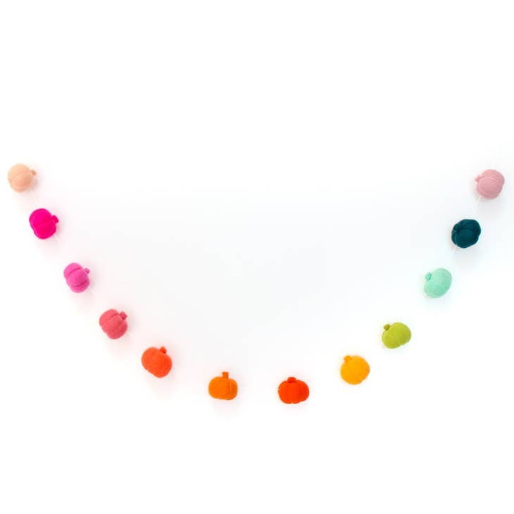 Five-foot rainbow felt pumpkin garland with twelve orange pumpkins spaced along a green vine.