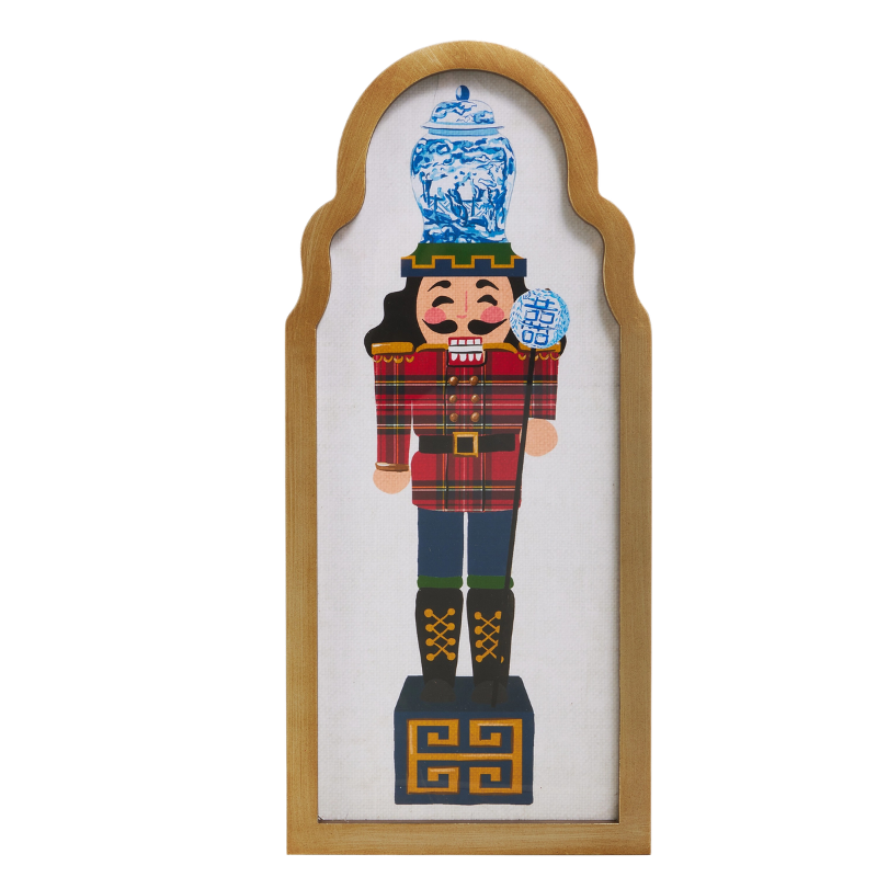 15.75" framed wall art featuring a nutcracker in a red plaid jacket with a blue and white ginger jar.